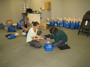 Trainees practicing CPR on a training mannequin